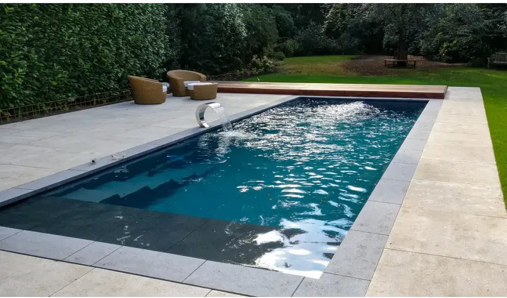 Leisurepools Cube pool – modern design, outdoors, deep blue water, grey stone paving